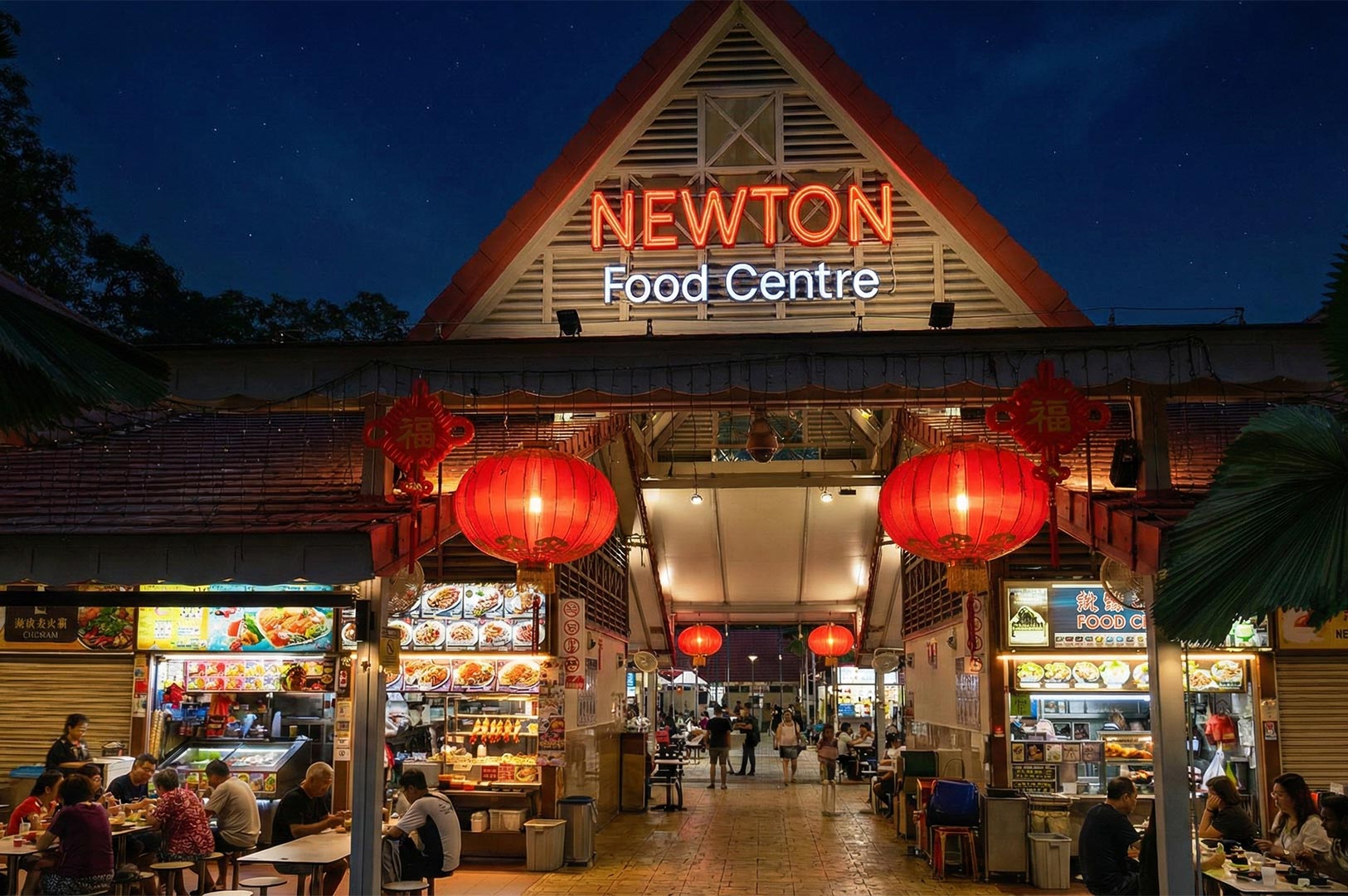 The illuminated entrance of the famous Newton Food Centre in Singapore at night, decorated with red lanterns and a bright neon sign.