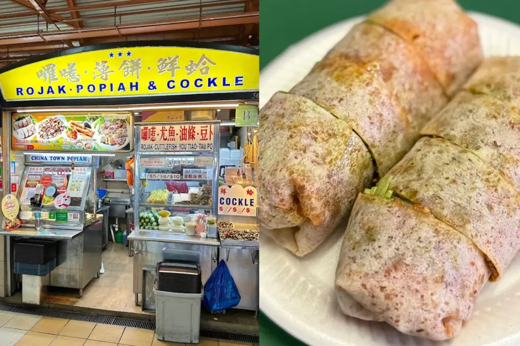A split-screen image highlighting a traditional snack stall. The left side features the "Rojak • Popiah & Cockle" stall, also known as "China Town Popiah." The stall has a bright yellow curved sign with blue and red text. A glass display case at the front shows various ingredients, including stacks of popiah skins, fresh cucumbers, and other fillings. A small sign on the right side of the counter advertises "Cockle" at various price points. The right side is a close-up of two large popiah rolls served on a white plate. The thin, translucent wheat skins are tightly wrapped around a dense filling, with hints of green vegetables and brown sauce visible through the wrapper. The rolls are cut into manageable bite-sized sections.