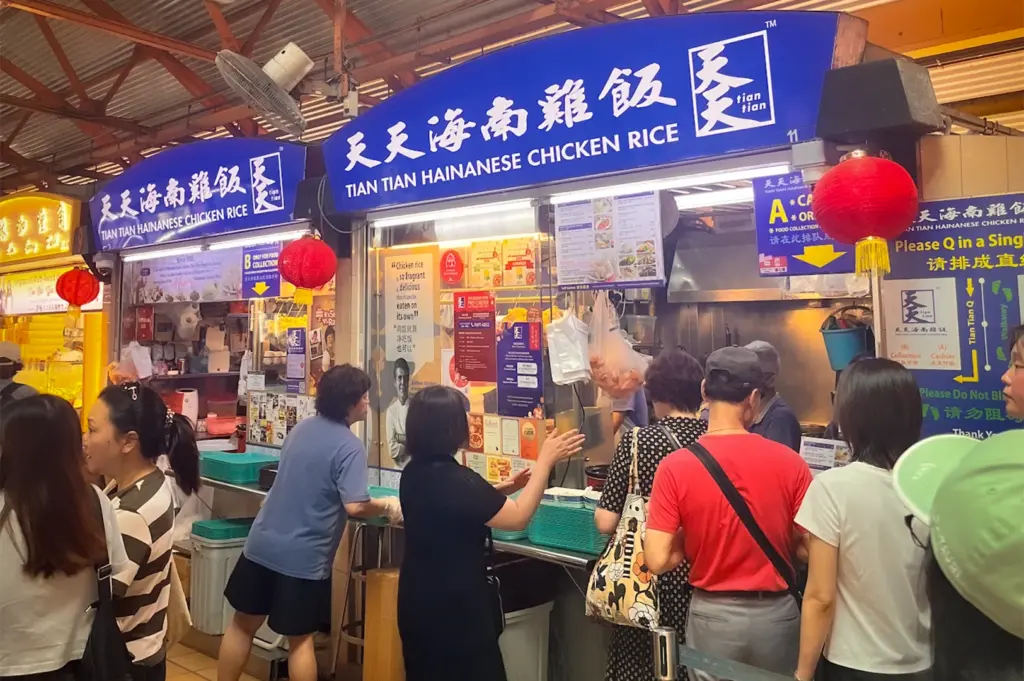 Tian Tian Hainanese Chicken Rice stall at Maxwell Food Centre Singapore featuring the famous Michelin-recognized hawker stall with blue signage and traditional chicken rice preparation area